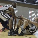 San Antonio Spurs Manu Ginobili right, is helped up by teammate San Antonio Spurs Jonathon Simmons, a in the first half of their regular-season NBA basketball game in Mexico City, Saturday, Jan. 14, 2017. (AP Photo/Rebecca Blackwell)