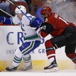 Vancouver Canucks defenseman Troy Stecher, left, tries to keep the puck away from Arizona Coyotes center Martin Hanzal (11) during the first period of an NHL hockey game Thursday, Jan. 26, 2017, in Glendale, Ariz. (AP Photo/Ross D. Franklin)