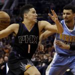 Phoenix Suns guard Devin Booker (1) drives on Denver Nuggets guard Jamal Murray during the third quarter of an NBA basketball game, Saturday, Jan. 28, 2017, in Phoenix. Denver defeated Phoenix 123-112. (AP Photo/Rick Scuteri)