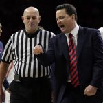 Arizona head coach Sean Miller talks with NCAA official Rick Randall after a technical foul call on Chance Comanche during the second half of an NCAA college basketball game, Saturday, Jan. 7, 2017, in Tucson, Ariz. Arizona defeated Colorado 82-73. (AP Photo/Rick Scuteri)