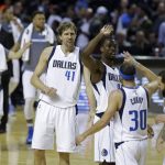 Dallas Mavericks Harrison Barnes, third from right, celebrates with teammate Seth Curry (30) as time runs out at the end of their regular-season NBA basketball game against the Phoenix Suns in Mexico City, Thursday, Jan. 12, 2017. At center is Dirk Nowitzki (41).(AP Photo/Rebecca Blackwell)