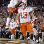 Clemson's Hunter Renfrow is congratulated by teammate Deon Cain after catching a touchdown pass during the second half of the NCAA college football playoff championship game against Alabama Monday, Jan. 9, 2017, in Tampa, Fla. (AP Photo/John Bazemore)