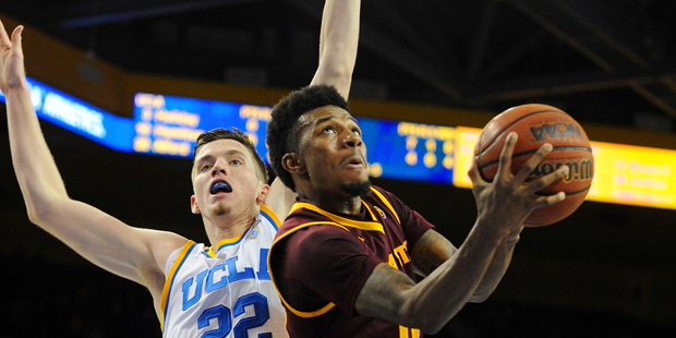 Arizona State guard Shannon Evans II, right, shoots a reverse layup behind UCLA's T.J. Leaf (22) du...