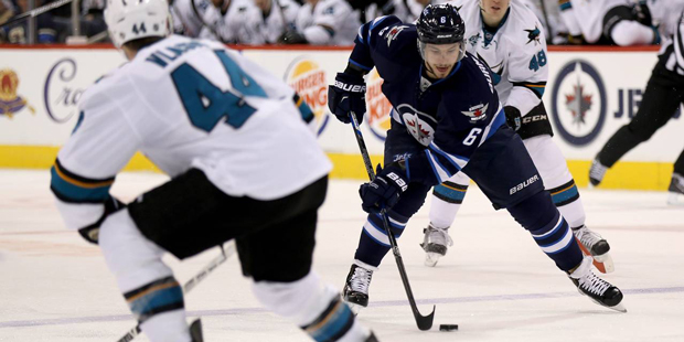 Winnipeg Jets' Alexander Burmistrov (6) carries the puck into the San Jose Sharks' zone during the ...