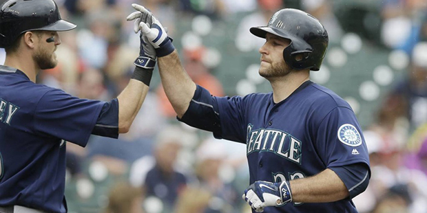 Seattle Mariners' Chris Iannetta, right, is congratulated by Shawn O'Malley after hitting a solo ho...