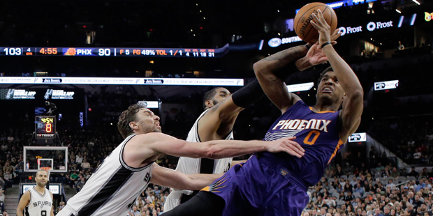 Phoenix Suns forward Marquese Chriss (0) tries to shoot past San Antonio Spurs defenders Pau Gasol,...