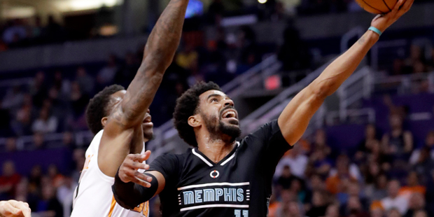 Memphis Grizzlies guard Mike Conley (11) shoots over Phoenix Suns guard Eric Bledsoe during the fir...