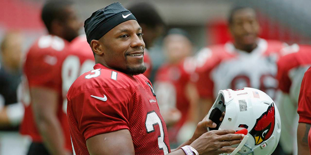 Arizona Cardinals' David Johnson smiles as he gets ready to put his helmet on during practice at th...