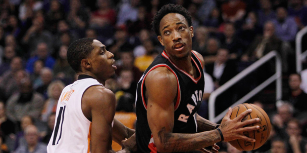 Phoenix Suns guard Brandon Knight, left, pressures Toronto Raptors guard DeMar DeRozan during the f...