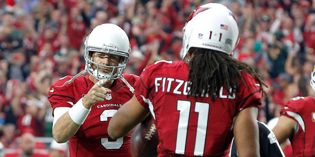 Arizona Cardinals quarterback Carson Palmer (3) points to wide receiver Larry Fitzgerald (11) after...