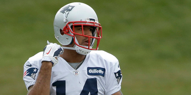 New England Patriots wide receiver Michael Floyd adjusts the strap on his helmet during NFL footbal...