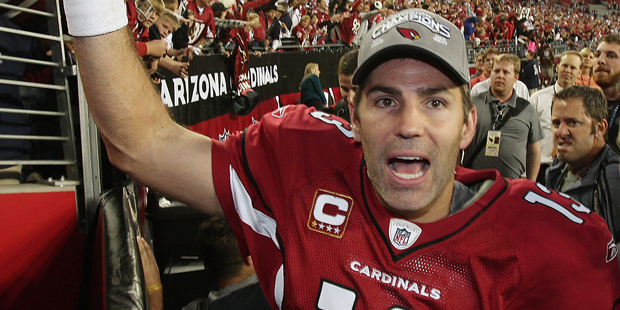 Arizona Cardinals' Kurt Warner celebrates with fans as he leaves the field after the Cardinals vict...