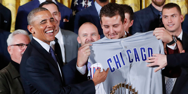 President Barack Obama is presented with personalized Chicago Cubs baseball away jersey by Anthony ...