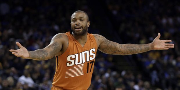 Phoenix Suns' P.J. Tucker gestures after being called for a foul during the second half of the team...