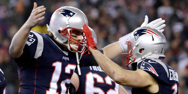 New England Patriots quarterback Tom Brady (12) celebrates with wide receiver Julian Edelman (11) a...