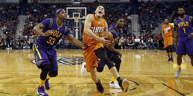 Phoenix Suns guard Devin Booker (1) drives to the basket in the first half of an NBA basketball gam...