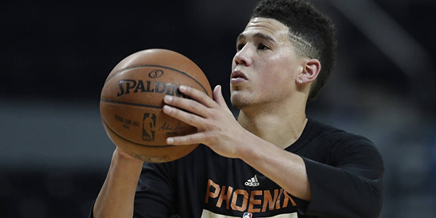 Phoenix Suns' Devin Booker shoot baskets during a training session the day before their game agains...