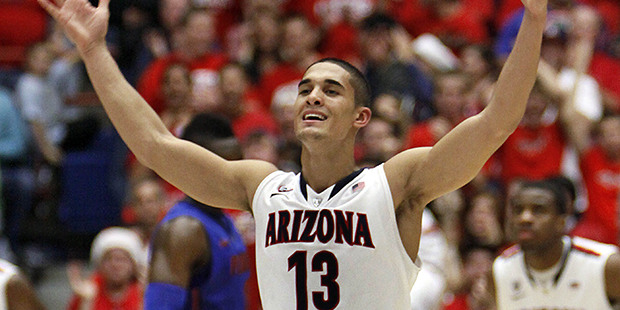 Arizona's Nick Johnson (13) rallys the crowd against Florida during the second half of an NCAA coll...