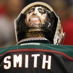 Arizona Coyotes' Mike Smith wears an autographed drawing of rock legend Alice Cooper on the back of his goalie helmet during the first period of an NHL hockey game against the Vancouver Canucks Thursday, March 5, 2015, in Glendale, Ariz. (AP Photo/Ross D. Franklin)