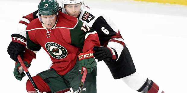 Arizona Coyotes defenseman Jakob Chychrun (6) reaches for the puck against Minnesota Wild left wing...