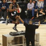 Los Angeles Clippers center DeAndre Jordan leaps over the turntable of DJ Khaled during the slam-dunk contest as part of the NBA All-Star Saturday Night events in New Orleans, Saturday, Feb. 18, 2017. (AP Photo/Max Becherer)
