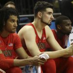 Arizona's Keanu Pinder, left, Dusan Ristic and Kadeem Allen watch from the bench as Oregon closes out the NCAA college basketball game with a 85-58 win Saturday, Feb. 4, 2017, in Eugene, Ore. (AP Photo/Chris Pietsch)