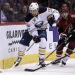 Buffalo Sabres right wing Justin Bailey (56) shields Arizona Coyotes defenseman Anthony DeAngelo from the puck in the first period during an NHL hockey game, Sunday, Feb. 26, 2017, in Glendale, Ariz. (AP Photo/Rick Scuteri)
