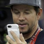Actor Mark Wahlberg looks at his phone while on the sidelines, before the NFL Super Bowl 51 football game between the New England Patriots and the Atlanta Falcons, Sunday, Feb. 5, 2017, in Houston. (AP Photo/Matt Slocum)