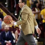Stanford head coach Jerod Haase carries the basketball to the referee during the first half of an NCAA college basketball game against Arizona State, Saturday, Feb. 11, 2017, in Tempe, Ariz. (AP Photo/Matt York)