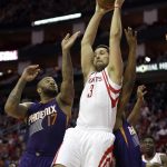 Houston Rockets' Ryan Anderson (3) and Phoenix Suns' P.J. Tucker (17) reach for a rebound during the first half of an NBA basketball game, Saturday, Feb. 11, 2017, in Houston. (AP Photo/David J. Phillip)
