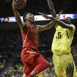 Arizona's Allonzo Trier, left, goes up for two points against Oregon's Chris Boucher during the second half of an NCAA college basketball game Saturday, Feb. 4, 2017, in Eugene, Ore. (AP Photo/Chris Pietsch)