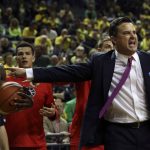 With Oregon's Dylan Ennis, left, looking on, Arizona head coach Sean Miller, right, questions a call during the second half of an NCAA college basketball game Saturday, Feb. 4, 2017, in Eugene, Ore. (AP Photo/Chris Pietsch)
