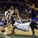Milwaukee Bucks' Giannis Antetokounmpo (34) dives for the ball against Phoenix Suns' Devin Booker (1) and Marquese Chriss (0) during the first half of an NBA basketball game Sunday, Feb. 26, 2017, in Milwaukee. (AP Photo/Jeffrey Phelps)