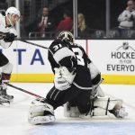 Arizona Coyotes left wing Brendan Perlini, o Britain, center, scores on Los Angeles Kings goalie Peter Budaj, right, of Slovakia, as defenseman Drew Doughty tries to defend during the first period of an NHL hockey game, Thursday, Feb. 16, 2017, in Los Angeles. (AP Photo/Mark J. Terrill)