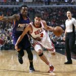 Chicago Bulls' Michael Carter-Williams (7) drives as Phoenix Suns' Eric Bledsoe defends during the first half of an NBA basketball game Friday, Feb. 24, 2017, in Chicago. (AP Photo/Charles Rex Arbogast)