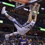 Memphis Grizzlies center Marc Gasol (33) hangs from the rim after dunking the ball in the second half of an NBA basketball game against the Phoenix Suns, Wednesday, Feb. 8, 2017, in Memphis, Tenn. (AP Photo/Brandon Dill)