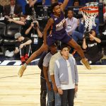 Phoenix Suns forward Derrick Jones Jr. (10) leaps over four people to make a dunk during the slam-dunk contest as part of the NBA All-Star Saturday Night events in New Orleans, Saturday, Feb. 18, 2017. (AP Photo/Max Becherer)