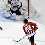 Chicago Blackhawks right wing Patrick Kane (88) scores a goal on Arizona Coyotes goalie Mike Smith (41) during the second period of an NHL hockey game Thursday, Feb. 23, 2017, in Chicago. (AP Photo/David Banks)