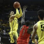 Oregon's Dillon Brooks, left, shoots a 3-point basket over Arizona's Rawle Alkins, center, with teammate Tyler Dorsey, right, watching during the first half of an NCAA college basketball game Saturday, Feb. 4, 2017, in Eugene, Ore. (AP Photo/Chris Pietsch)