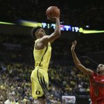 Oregon's Tyler Dorsey, left, shoot a 3-point shot over Arizona's Parker Jackson-Cartwright during the first half of an NCAA college basketball game Saturday, Feb. 4, 2017, in Eugene, Ore. (AP Photo/Chris Pietsch)