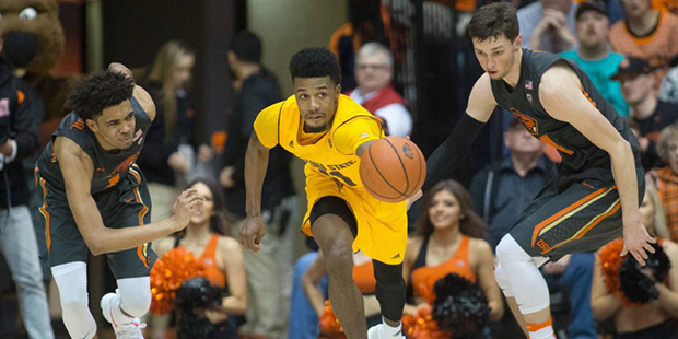 Arizona State's Andre Adams, center, beats the double team of Oregon State's Stephen Thompson Jr., ...