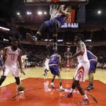 Phoenix Suns' Marquese Chriss (0) hangs on the rim after dunking the ball against the Houston Rockets during the first half of an NBA basketball game Saturday, Feb. 11, 2017, in Houston. (AP Photo/David J. Phillip)