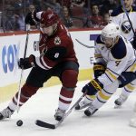 Arizona Coyotes right wing Tobias Rieder (8) shields the puck from Buffalo Sabres defenseman Josh Gorges in the second period during an NHL hockey game, Sunday, Feb. 26, 2017, in Glendale, Ariz. (AP Photo/Rick Scuteri)