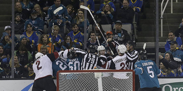 San Jose Sharks and Arizona Coyotes players are separated during a scuffle in the first period of a...