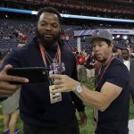 Seattle Seahawks' Michael Bennett, left, takes selfie with actor Mark Wahlberg before the NFL Super Bowl 51 football game Sunday, Feb. 5, 2017, in Houston. (AP Photo/David J. Phillip)