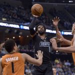 Memphis Grizzlies guard Mike Conley (11) shoots between Phoenix Suns guards Eric Bledsoe, from left, and Devin Booker (1), and center Alex Len in the first half of an NBA basketball game, Tuesday, Feb. 28, 2017, in Memphis, Tenn. (AP Photo/Brandon Dill)