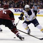Buffalo Sabres left wing Evander Kane (9) carries the puck in front of Arizona Coyotes defenseman Connor Murphy in the first period during an NHL hockey game, Sunday, Feb. 26, 2017, in Glendale, Ariz. (AP Photo/Rick Scuteri)