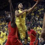 Arizona's Rawle Alkins, left, defends with teammate Kadeem Allen, right, as Oregon's Tyler Dorsey, center, drives to the basket during the first half of an NCAA college basketball game Saturday, Feb. 4, 2017, in Eugene, Ore. (AP Photo/Chris Pietsch)