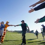 Phil Mickelson gives out a fist bump as he walks past the gallery on his way to the third hole during the third round of the Waste Management Phoenix Open golf tournament Saturday, Feb. 4, 2017, in Scottsdale, Ariz. (AP Photo/Ross D. Franklin)