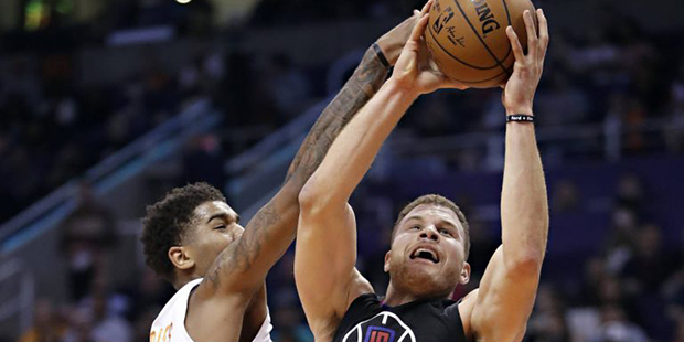 Los Angeles Clippers forward Blake Griffin (32) drives past Phoenix Suns forward Marquese Chriss du...